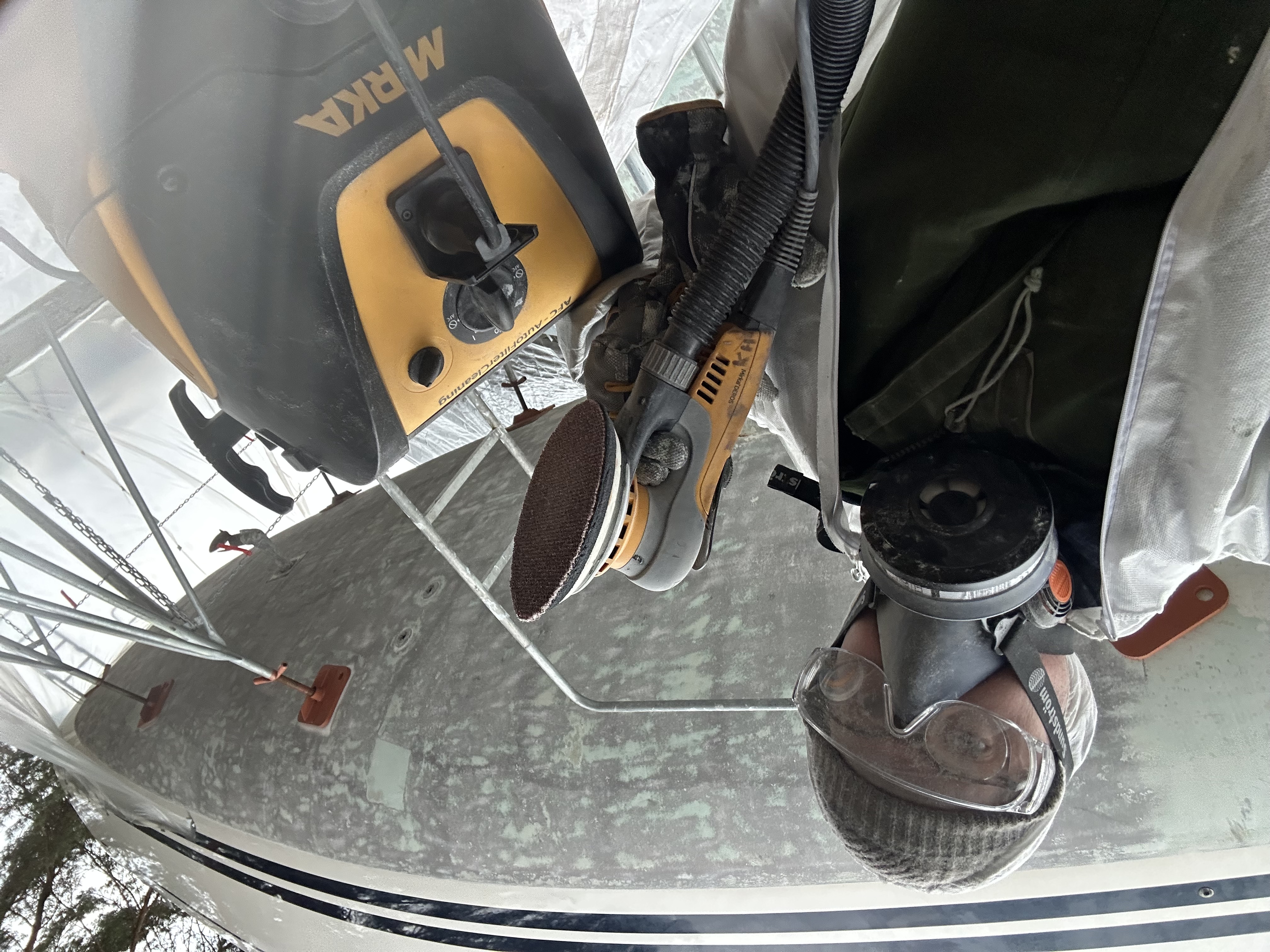 The bottom before we started — years of layered antifouling, worn and patchy