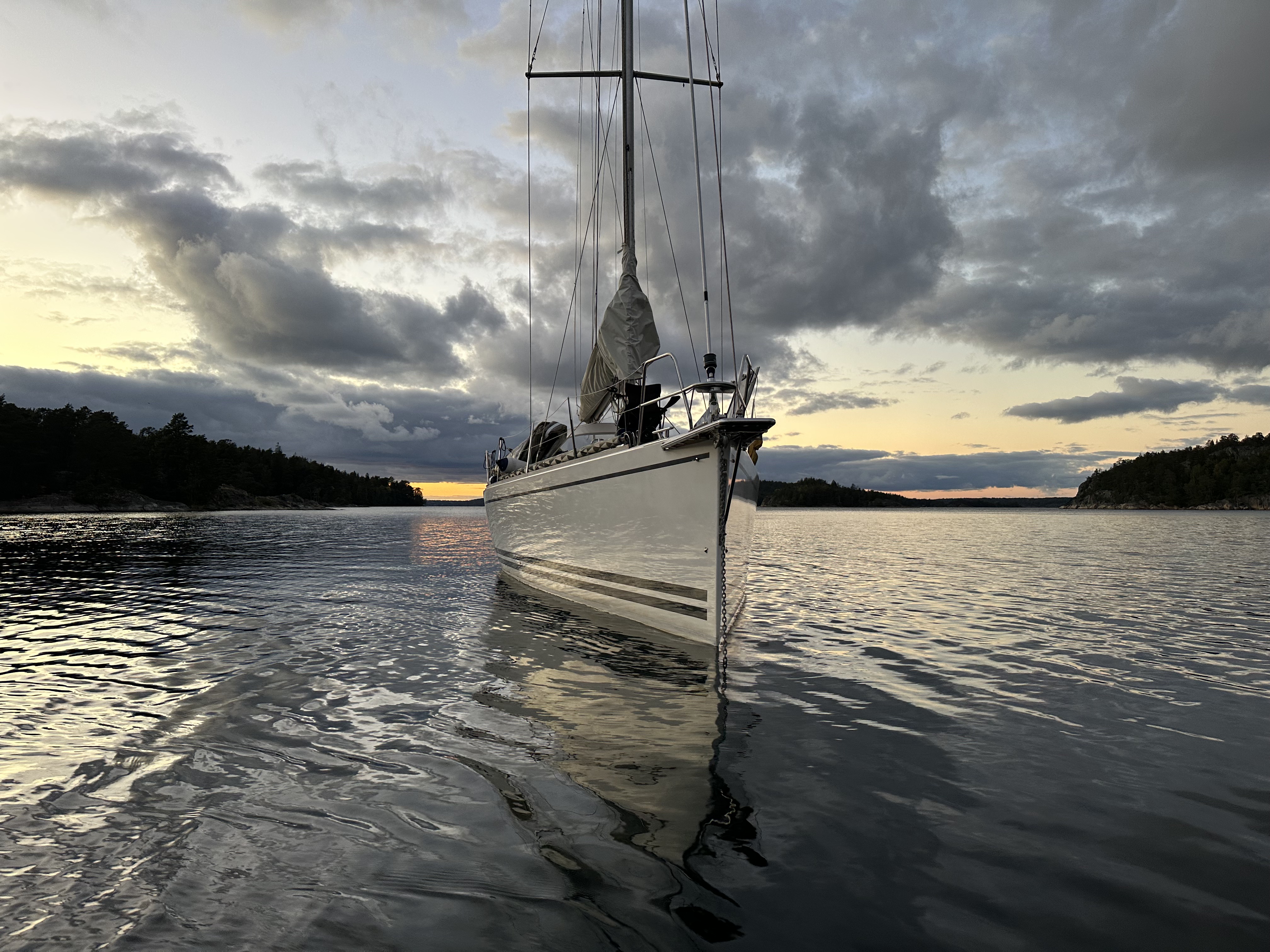 Iris bow-on at anchor under dramatic evening skies